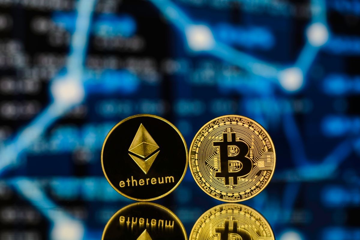 Bitcoin and Ethereum with reflexion against blurry background